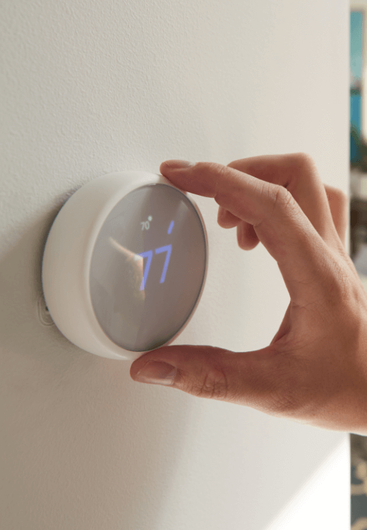 Men set temperature on his air conditioning system